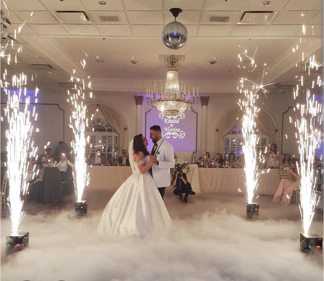 Wedding couple with indoor spark machines and low fog